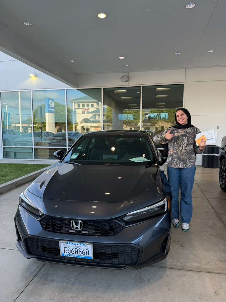 Client vehicle delivery — sedan at Honda dealership