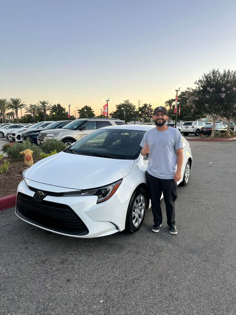Client vehicle delivery — sedan handoff at sunset